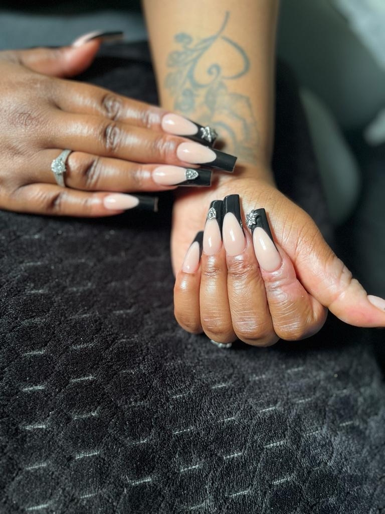 Black French tip acrylic nails with silver nail art