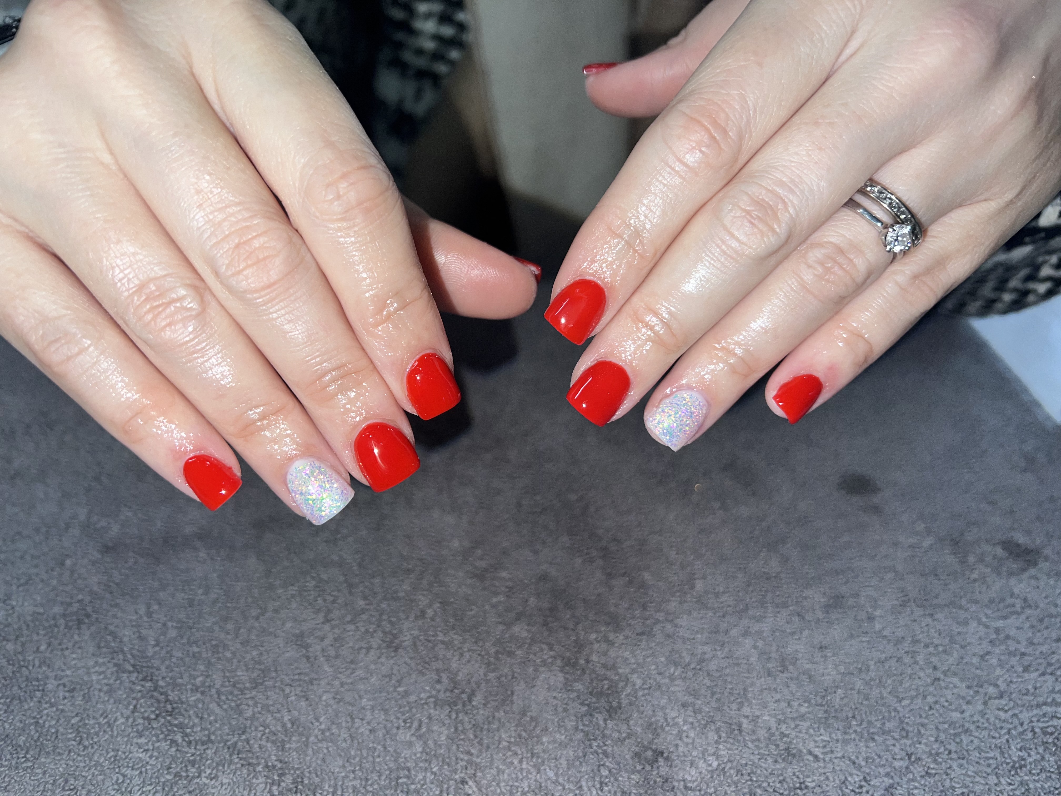 Red gel nails with glitter accent nail