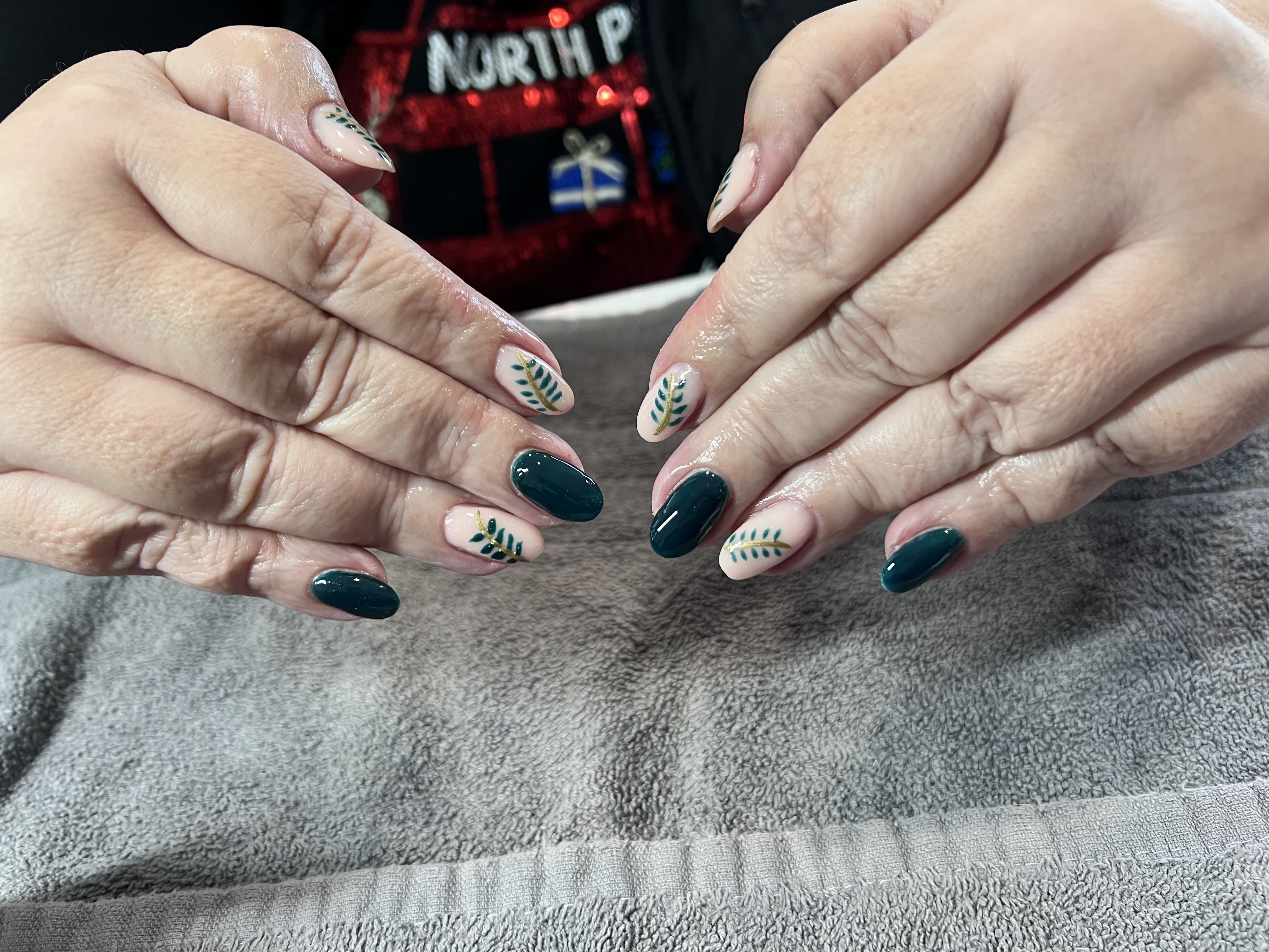 Dark teal gel nails with botanical nail art