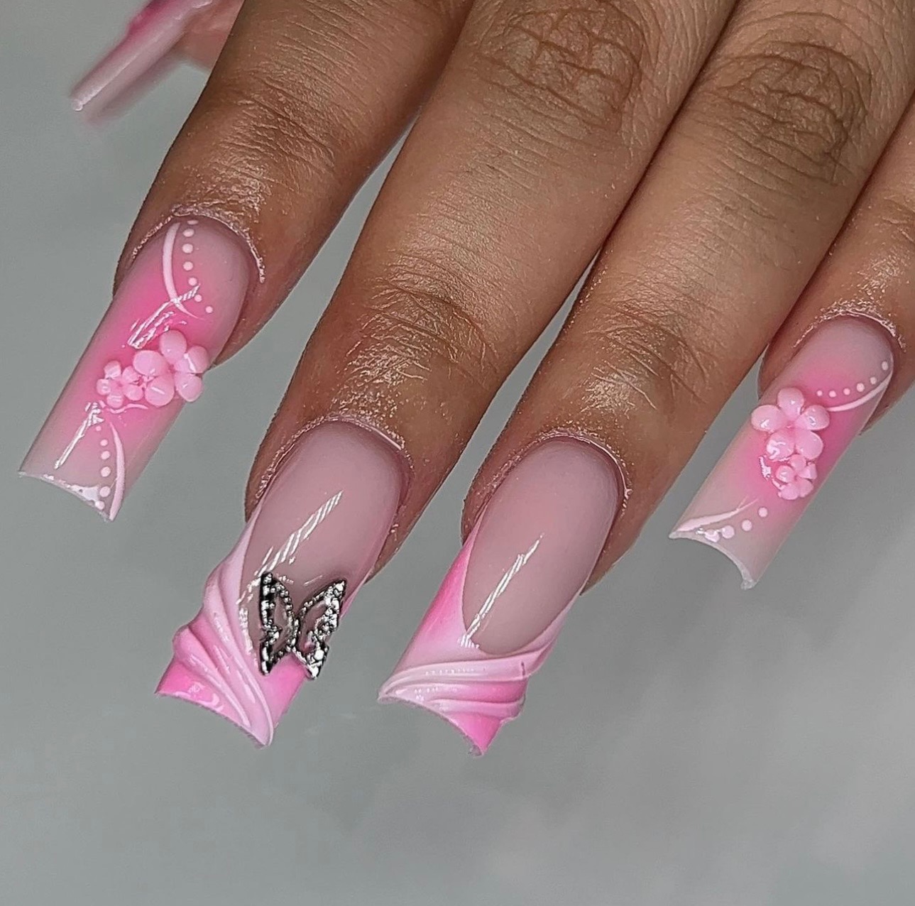 Pink ombre nails with butterfly charm and 3D flowers