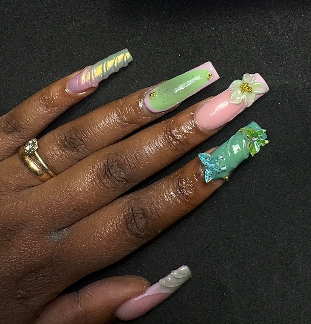 3D floral nail art in green and pink tones