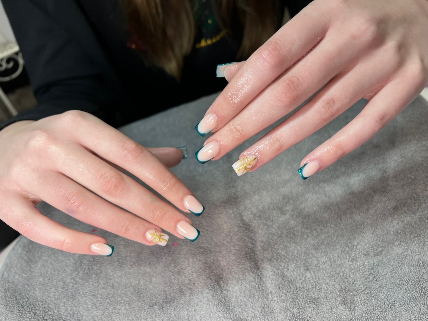 Teal French tips with gold bow nail art
